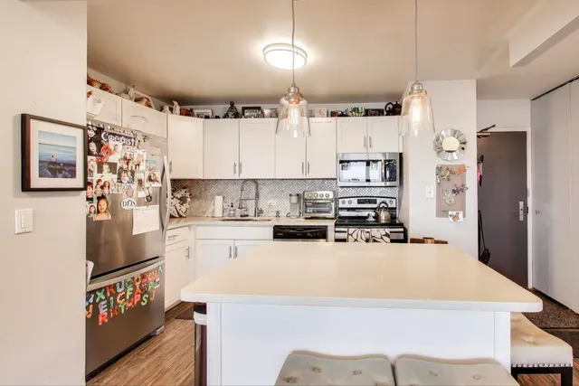 a kitchen with refrigerator and cabinets