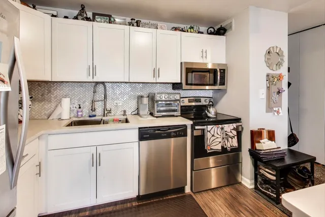 a kitchen with stainless steel appliances a stove a microwave and cabinets