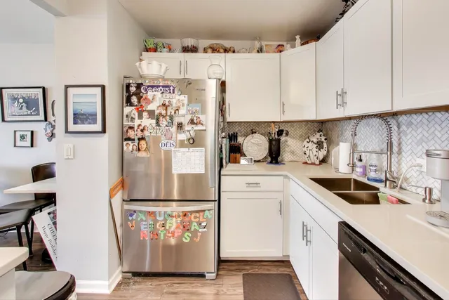 a kitchen with a white stove top oven and cabinets