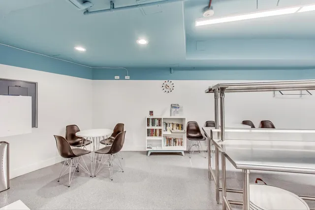 a view of a patio with a table and chairs and potted plants