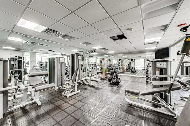 a living room with lots of furniture and large windows