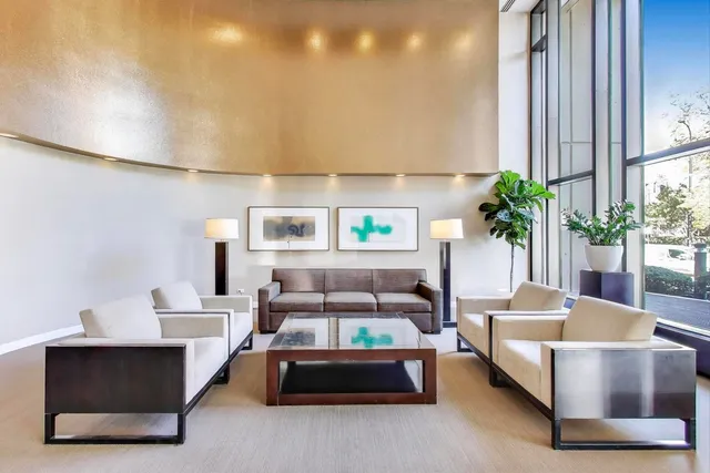 a living room with furniture and a potted plant