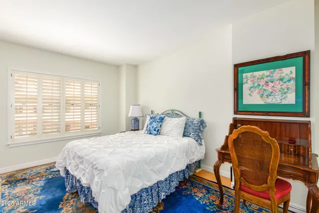 a bedroom with bed and a window