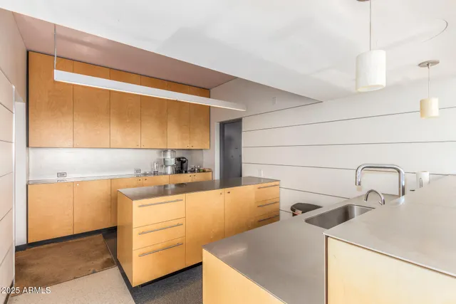 a kitchen with a sink a stove and cabinets