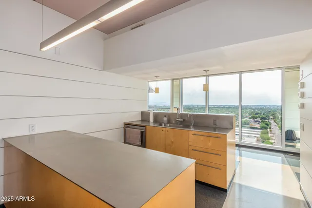 a living room with a large window with kitchen view