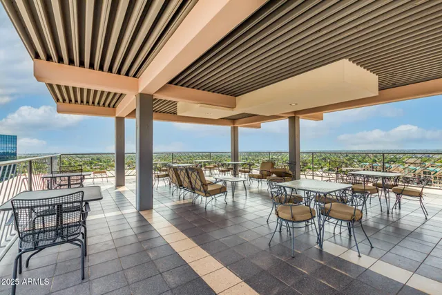 an outdoor space with furniture and city view