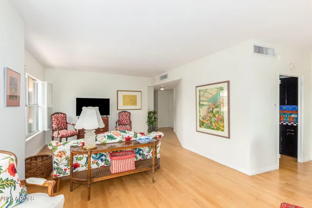 a bedroom with furniture and a wooden floor