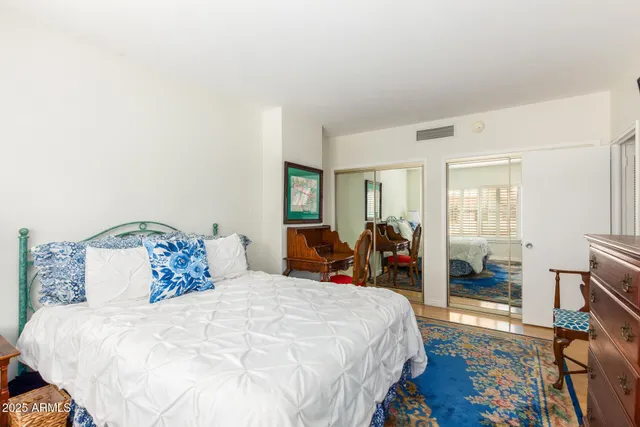 a bed room with a bed and a large mirror