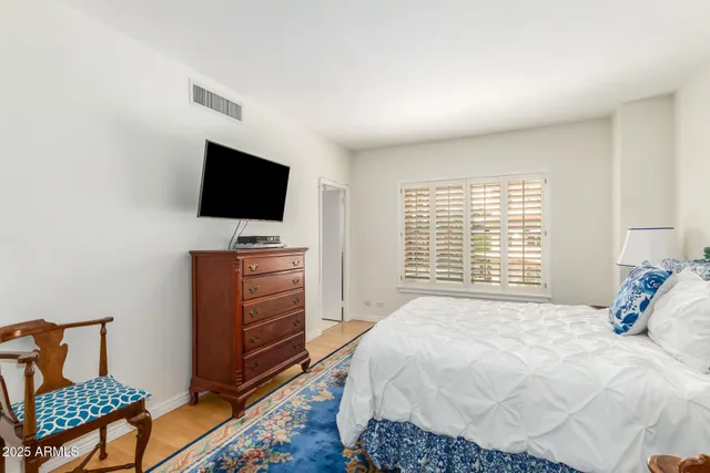 a bedroom with a bed and flat screen tv