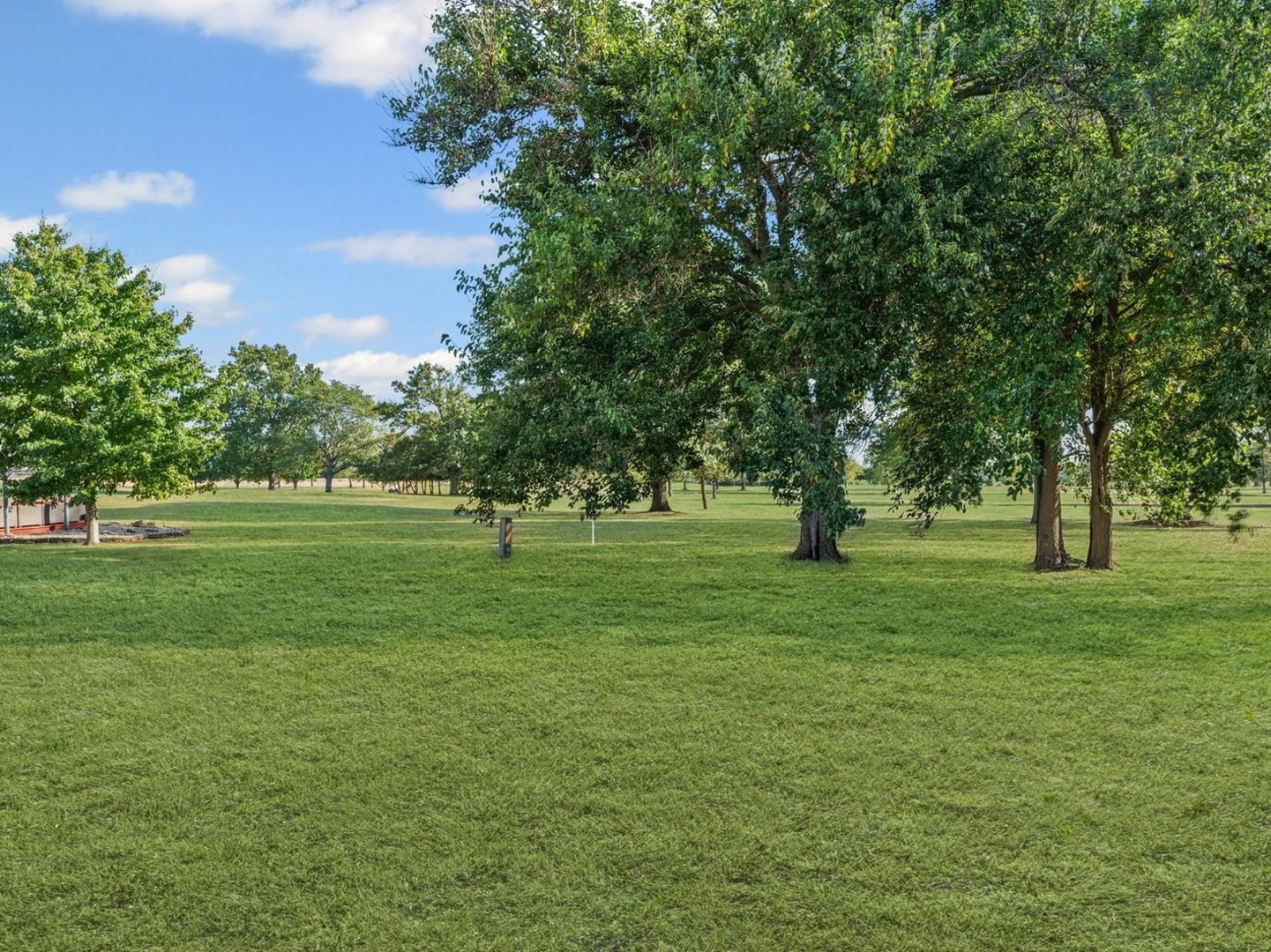 1602 Golfview Circle Rantoul, IL 61866 - Photo 31 of 36 a view of grassy field with benches and trees all around