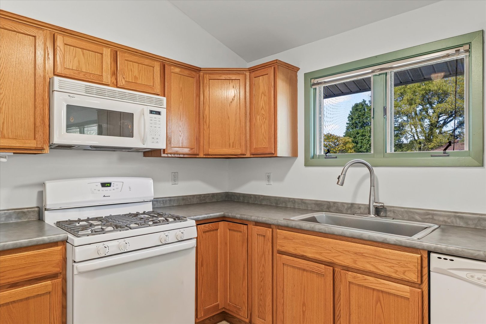 1602 Golfview Circle Rantoul, IL 61866 - Photo 7 of 36 a kitchen with stainless steel appliances granite countertop a stove a sink dishwasher and a microwave