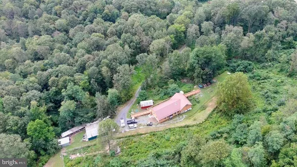 an aerial view of a house with a yard and outdoor seating