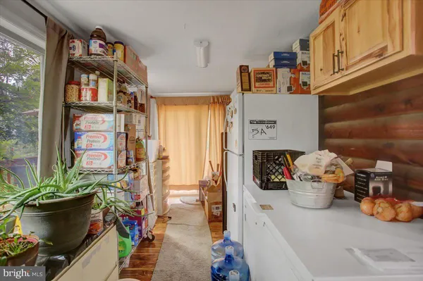 a kitchen with cabinets and chairs