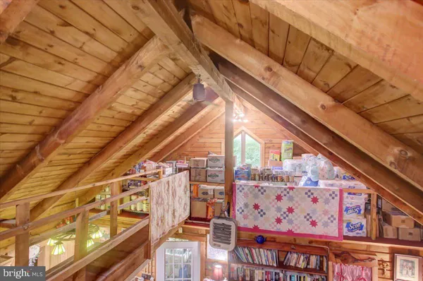 a bedroom with a bed a book shelf and a book shelf