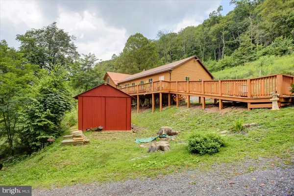 a view of a house with a yard and sitting area