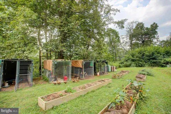 a view of a house with backyard patio and garden