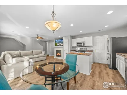 a living room with furniture kitchen and a chandelier