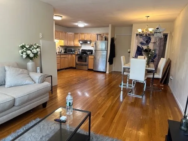 a living room with furniture and kitchen view