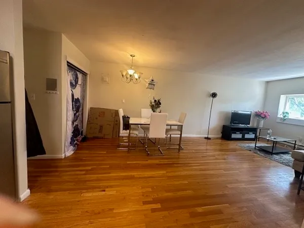 a living room with fireplace furniture and a wooden floor