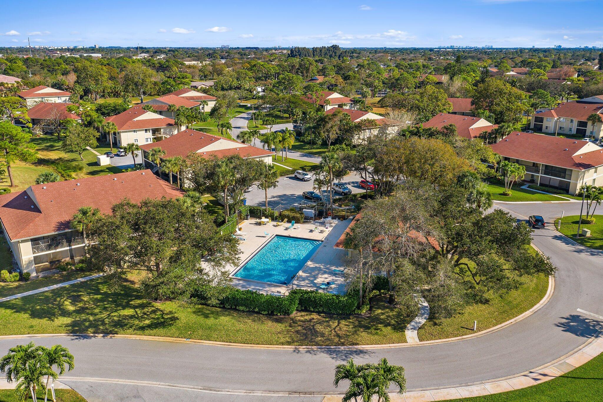 6532 Chasewood Drive, Unit F Jupiter, FL 33458 - Photo 1 of 17 an aerial view of residential houses with outdoor space and trees