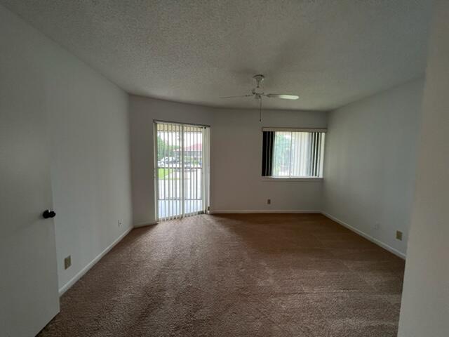 6532 Chasewood Drive, Unit F Jupiter, FL 33458 - Photo 11 of 17 a view of an empty room with a window