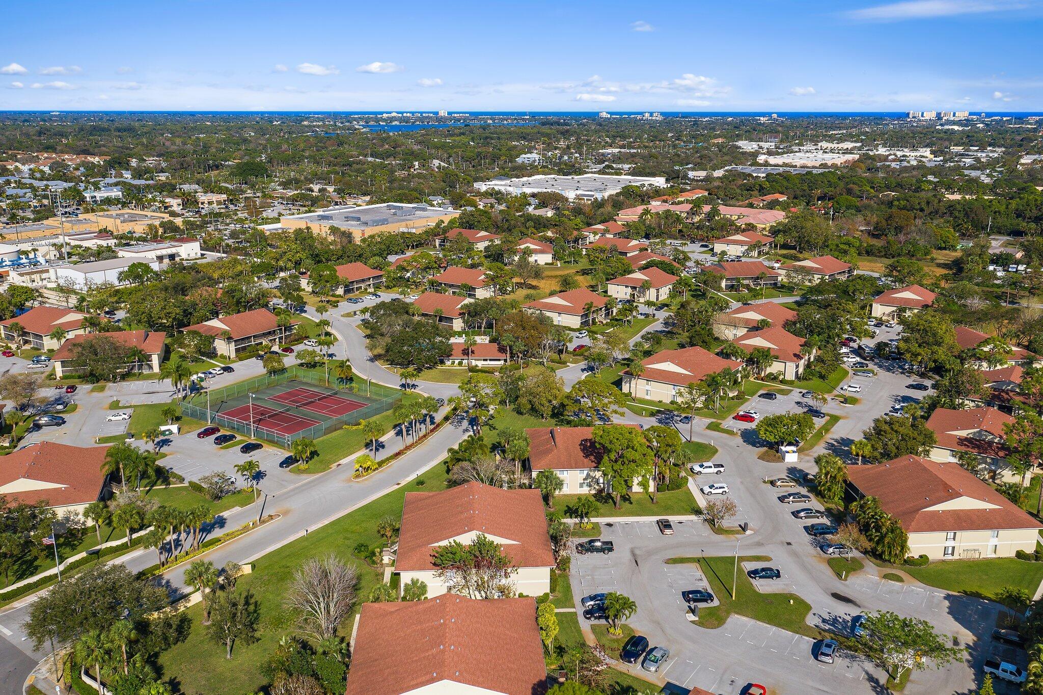 6532 Chasewood Drive, Unit F Jupiter, FL 33458 - Photo 5 of 17 an aerial view of residential houses with outdoor space