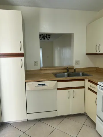 a kitchen with granite countertop cabinets and white appliances