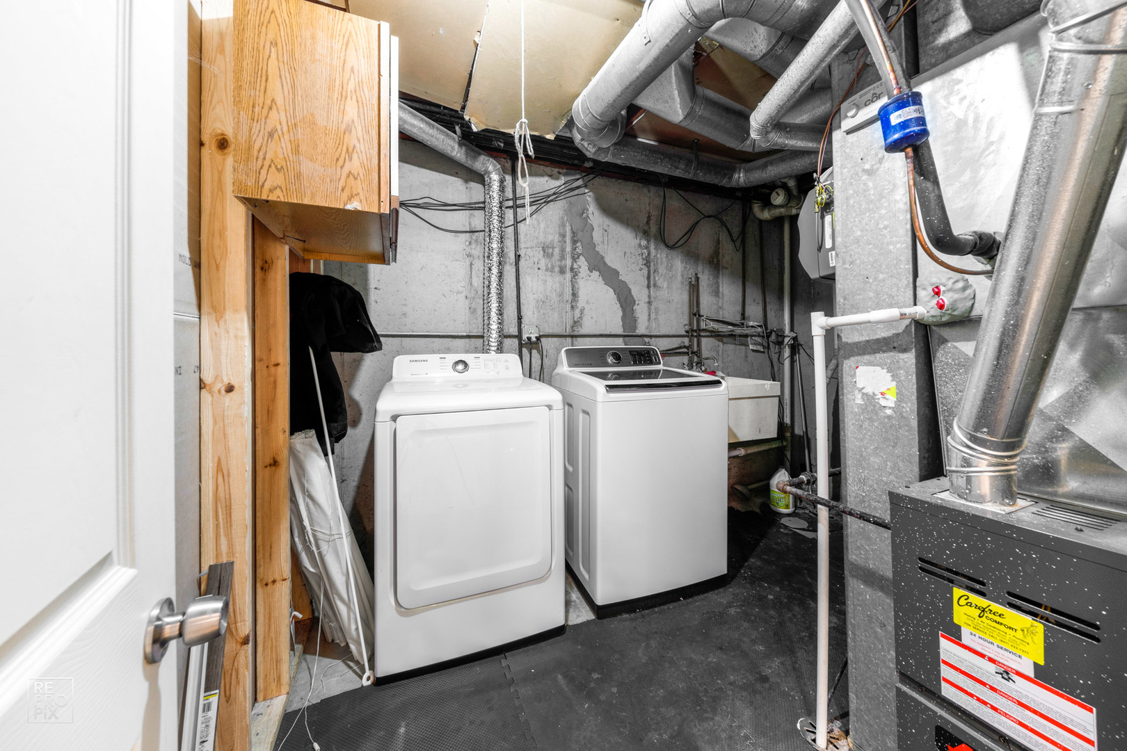 1306 Inverrary Lane, Unit 1306 Deerfield, IL 60015 - Photo 11 of 12 a view of a storage and utility room with washer and dryer