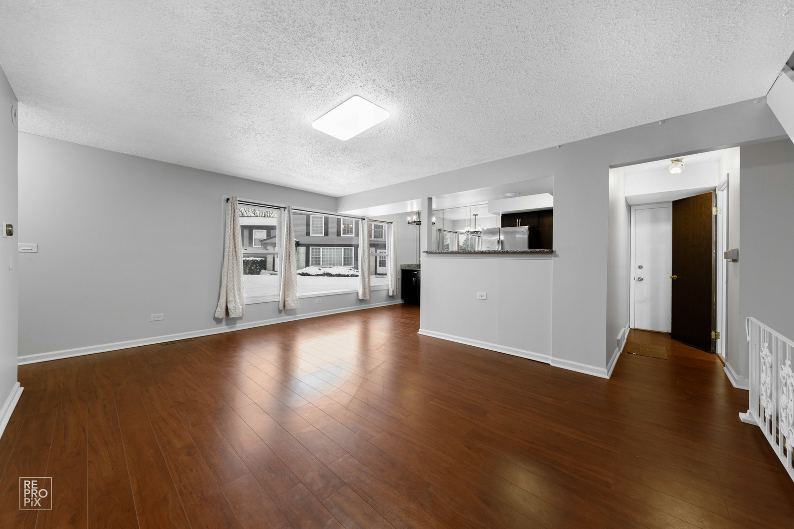 1306 Inverrary Lane, Unit 1306 Deerfield, IL 60015 - Photo 3 of 12 a view of a kitchen with wooden floor and a refrigerator