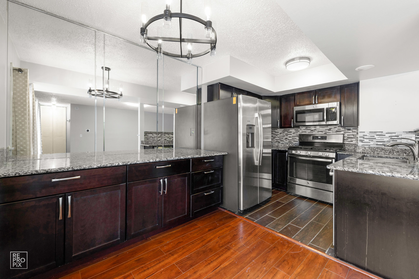 1306 Inverrary Lane, Unit 1306 Deerfield, IL 60015 - Photo 4 of 12 a kitchen with stainless steel appliances granite countertop a stove refrigerator and cabinets