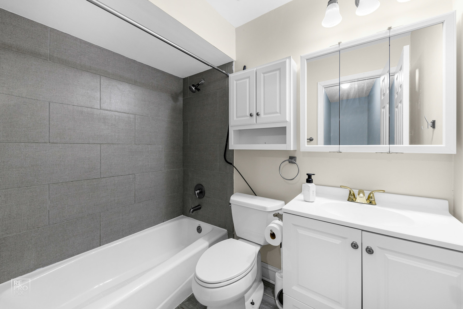1306 Inverrary Lane, Unit 1306 Deerfield, IL 60015 - Photo 7 of 12 a bathroom with a sink toilet vanity and shower