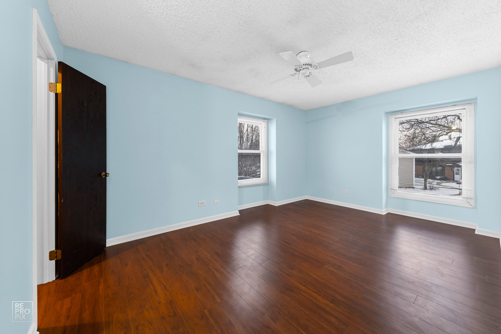 1306 Inverrary Lane, Unit 1306 Deerfield, IL 60015 - Photo 8 of 12 a view of an empty room with wooden floor and a window