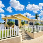 a view of a house with a wooden deck