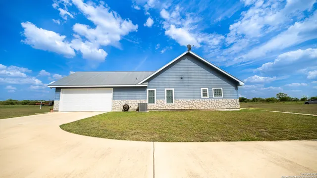 a view of a house with yard and ocean view
