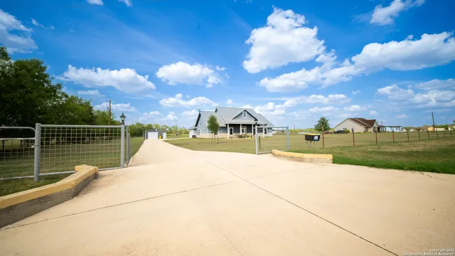a view of swimming pool that has lawn chairs with plants