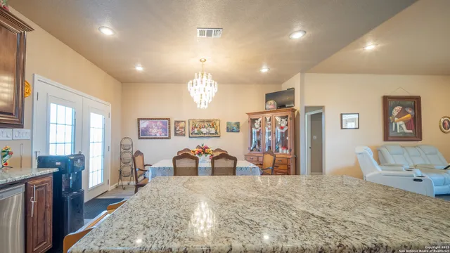a view of a bedroom with furniture and chandelier
