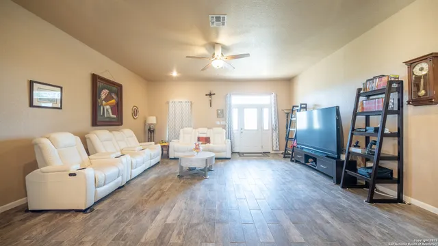 a living room with furniture and wooden floor