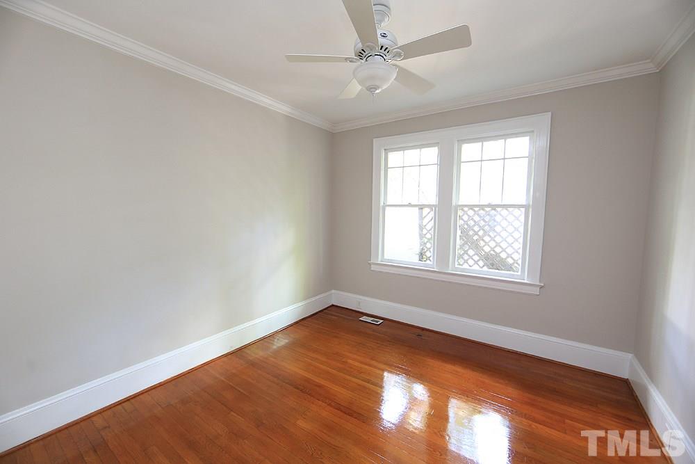 1906 Sunset Drive Raleigh, NC 27608 - Photo 13 of 21 an empty room with a window and ceiling fan