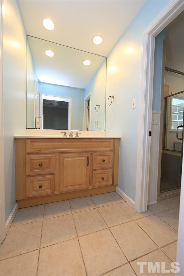 1906 Sunset Drive Raleigh, NC 27608 - Photo 14 of 21 a bathroom with a sink a mirror and a bathtub
