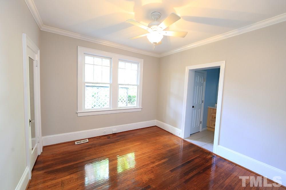 1906 Sunset Drive Raleigh, NC 27608 - Photo 16 of 21 an empty room with wooden floor and windows