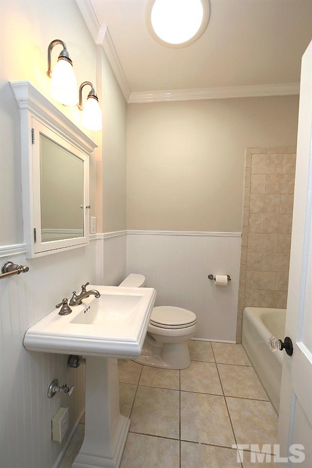 1906 Sunset Drive Raleigh, NC 27608 - Photo 18 of 21 a bathroom with a sink a toilet and mirror