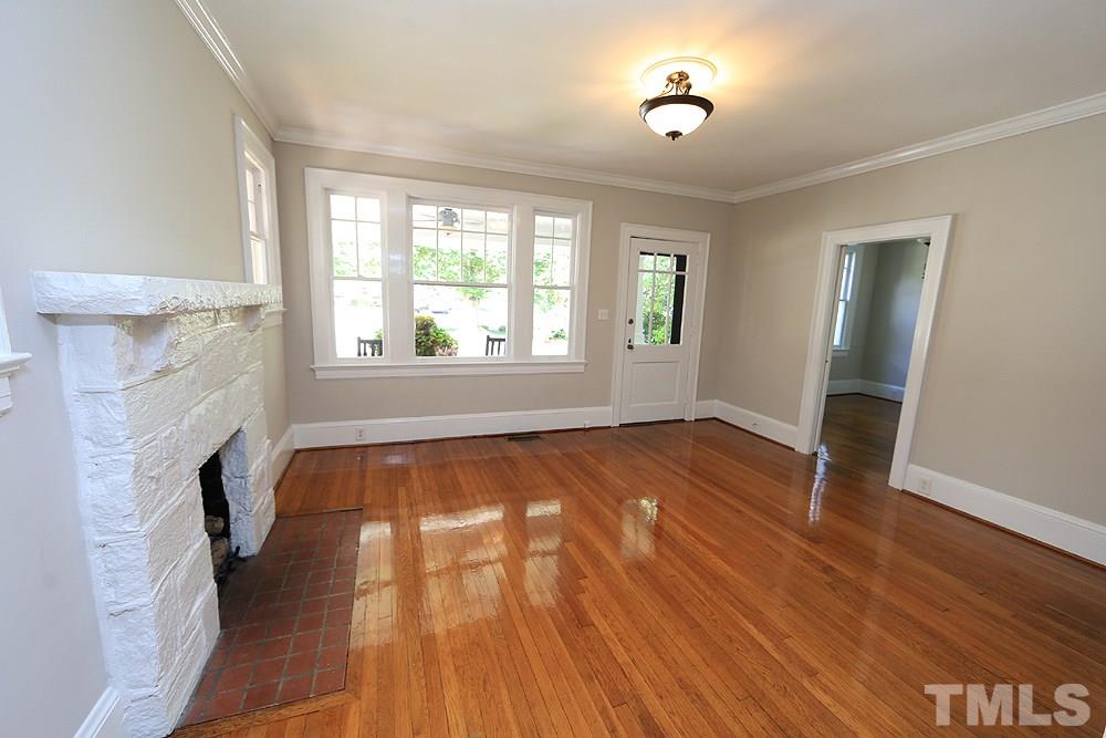 1906 Sunset Drive Raleigh, NC 27608 - Photo 6 of 21 an empty room with wooden floor and windows