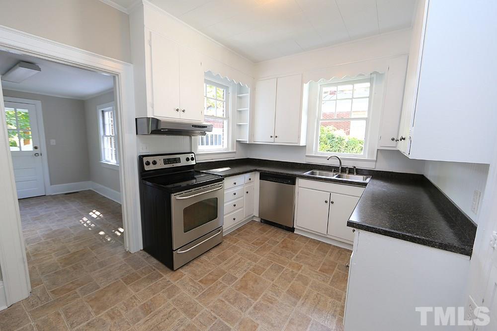 1906 Sunset Drive Raleigh, NC 27608 - Photo 8 of 21 a kitchen with granite countertop white cabinets and white appliances