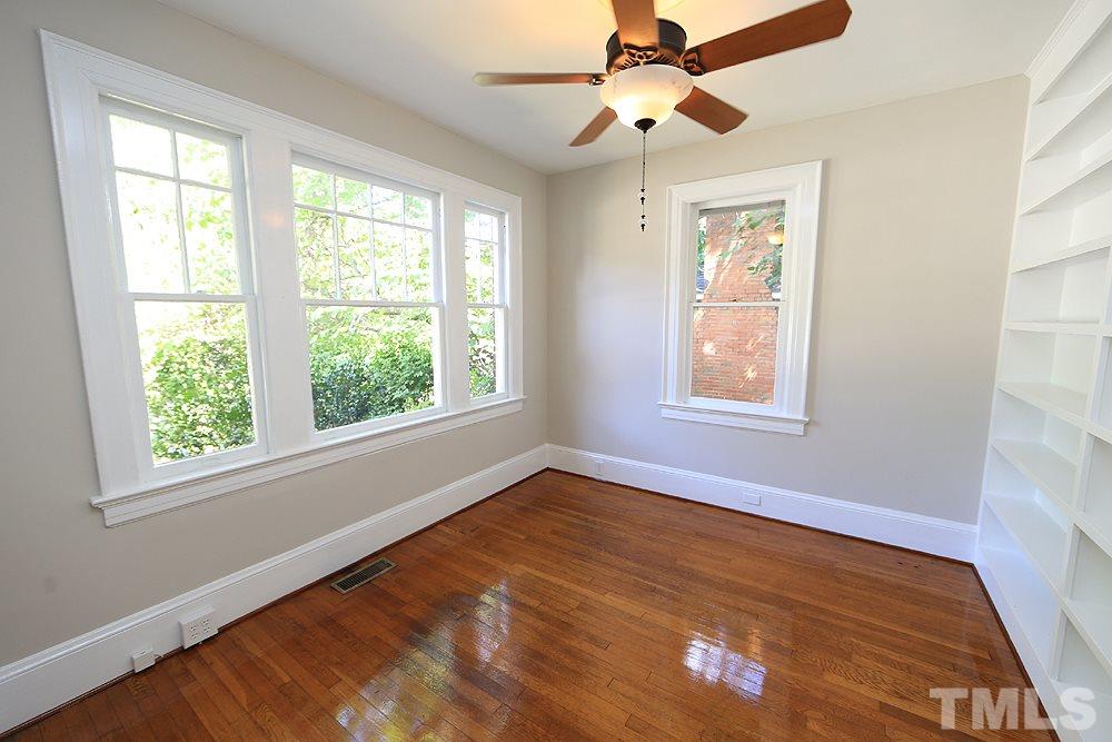 1906 Sunset Drive Raleigh, NC 27608 - Photo 10 of 21 a view of an empty room with wooden floor and a window