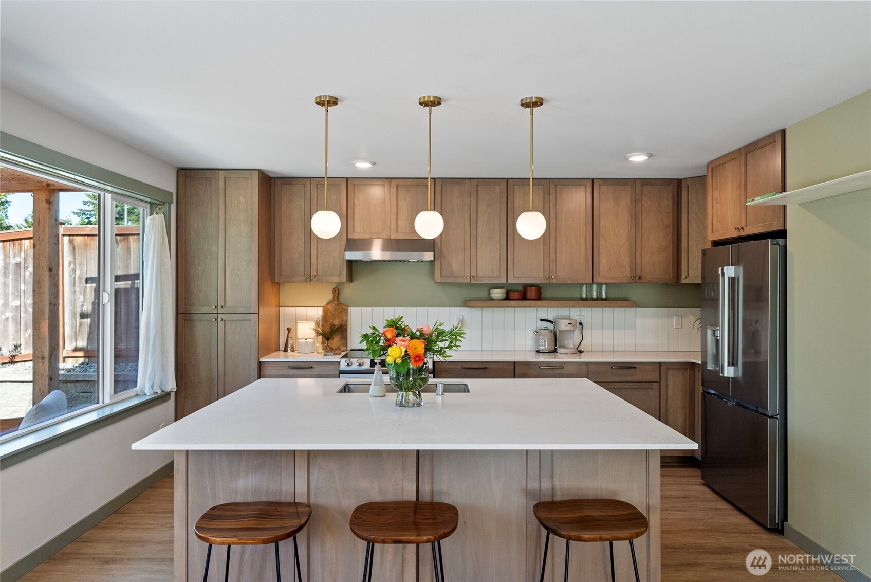 503 5th Street Steilacoom, WA 98388 - Photo 11 of 40 a kitchen with a table chairs sink and cabinets