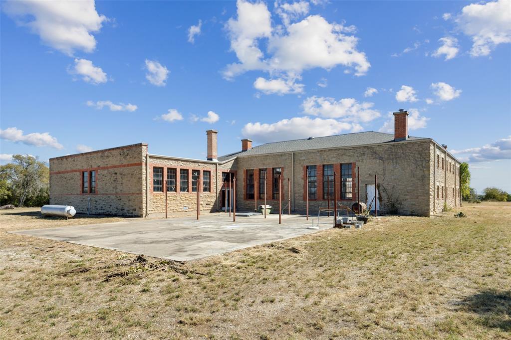 2591 Fm 1204 Decatur, TX 76234 - Photo 11 of 15 Rear view of property featuring brick siding, a yard, a patio area, and a chimney
