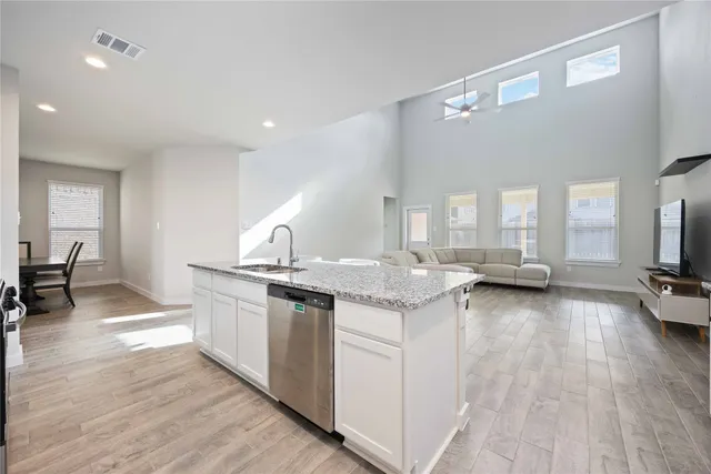a kitchen with granite countertop a stove and a wooden floors