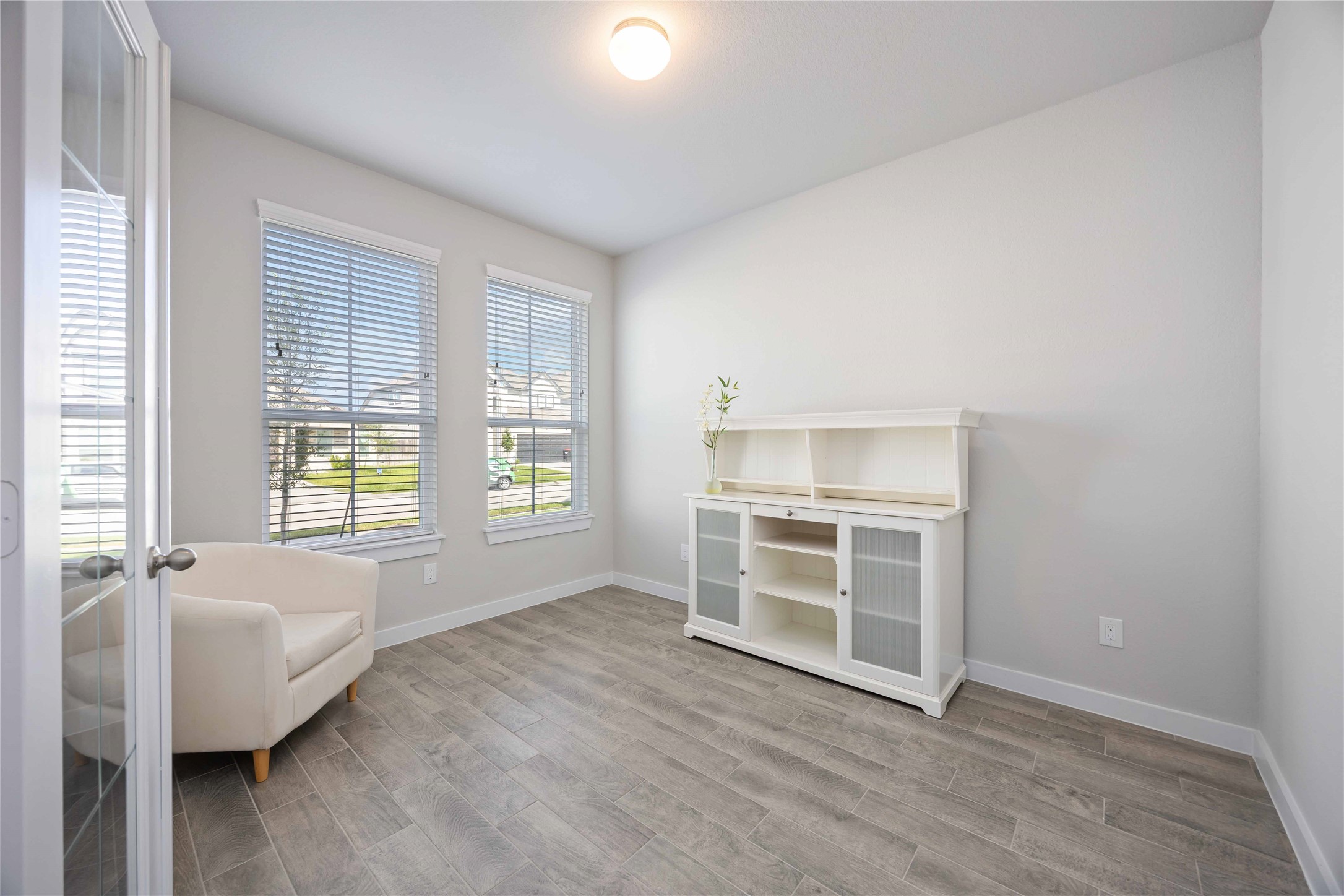 15038 Timberson Rdg Lane Houston, TX 77090 - Photo 13 of 29 a view of an empty room with a window and wooden floor