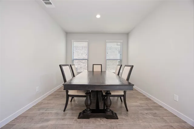a view of a dining room with furniture and window