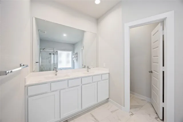 a bathroom with a double vanity sink and mirror